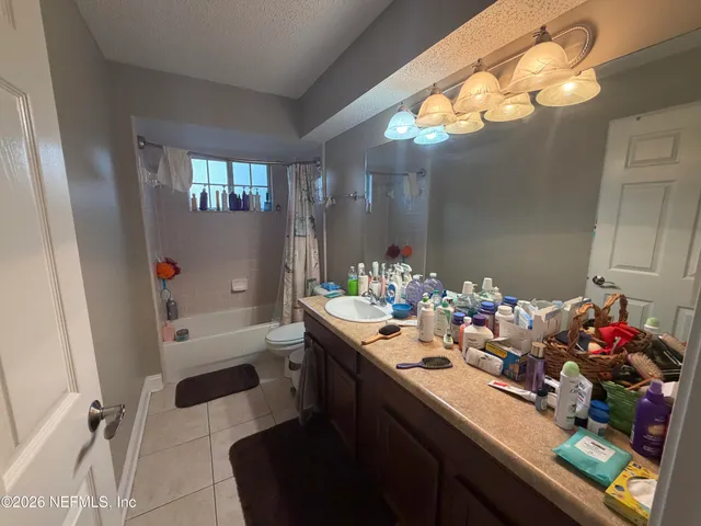 a bathroom with a sink mirror and vanity