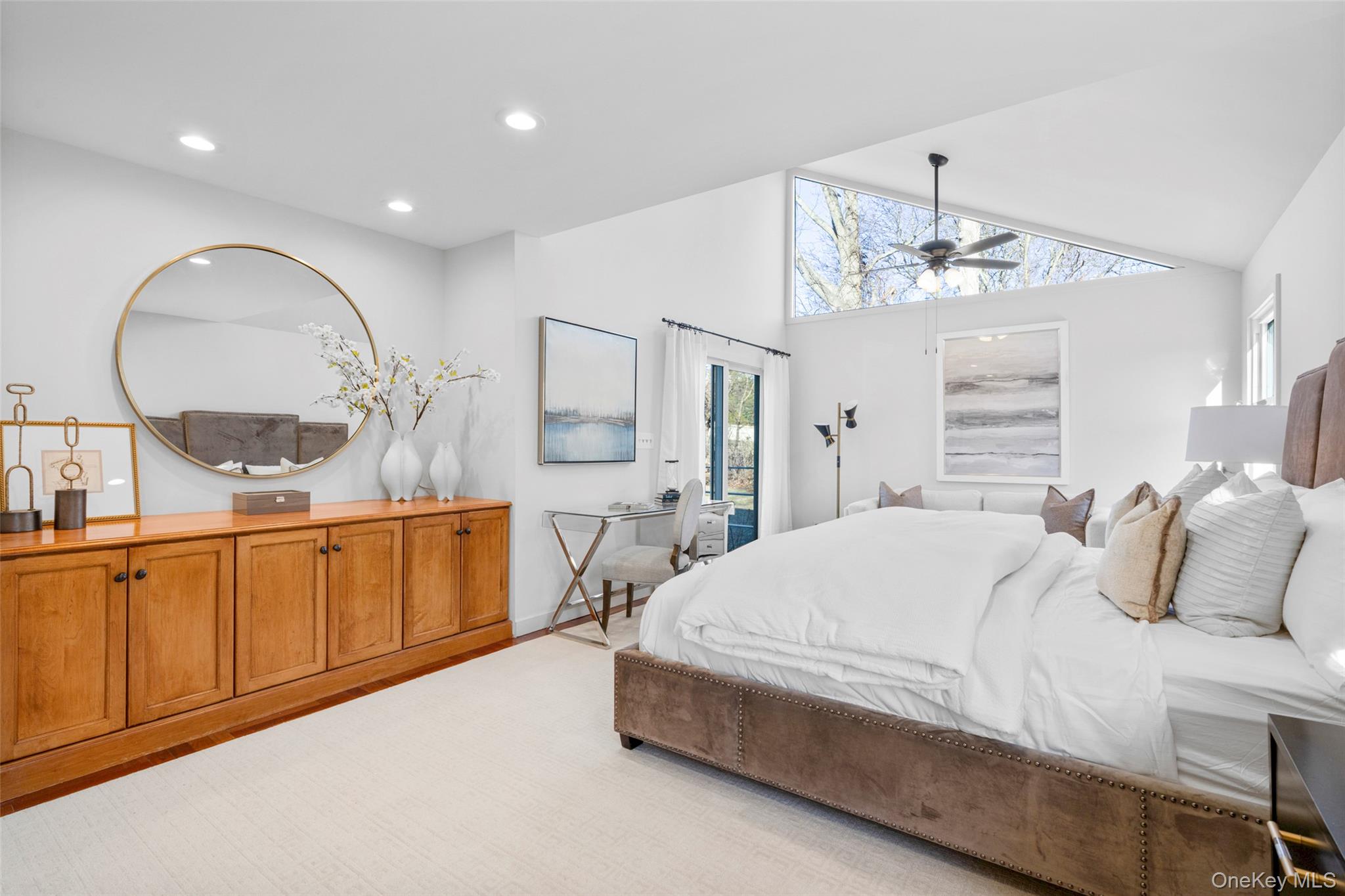 151 Hilburn Road Scarsdale, NY 10583 - Photo 19 of 40 a bedroom with a large bed and a chandelier