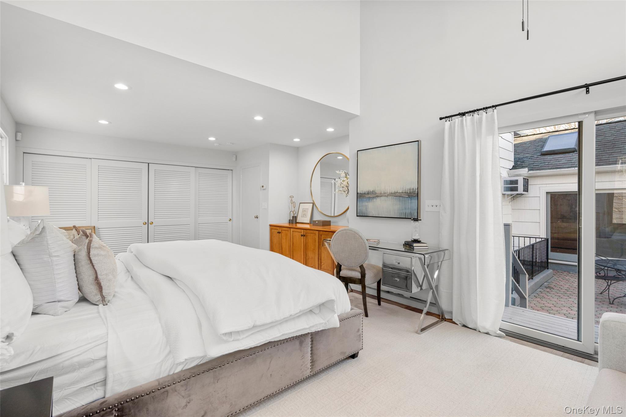 151 Hilburn Road Scarsdale, NY 10583 - Photo 20 of 40 a spacious bedroom with a bed and a view of living room