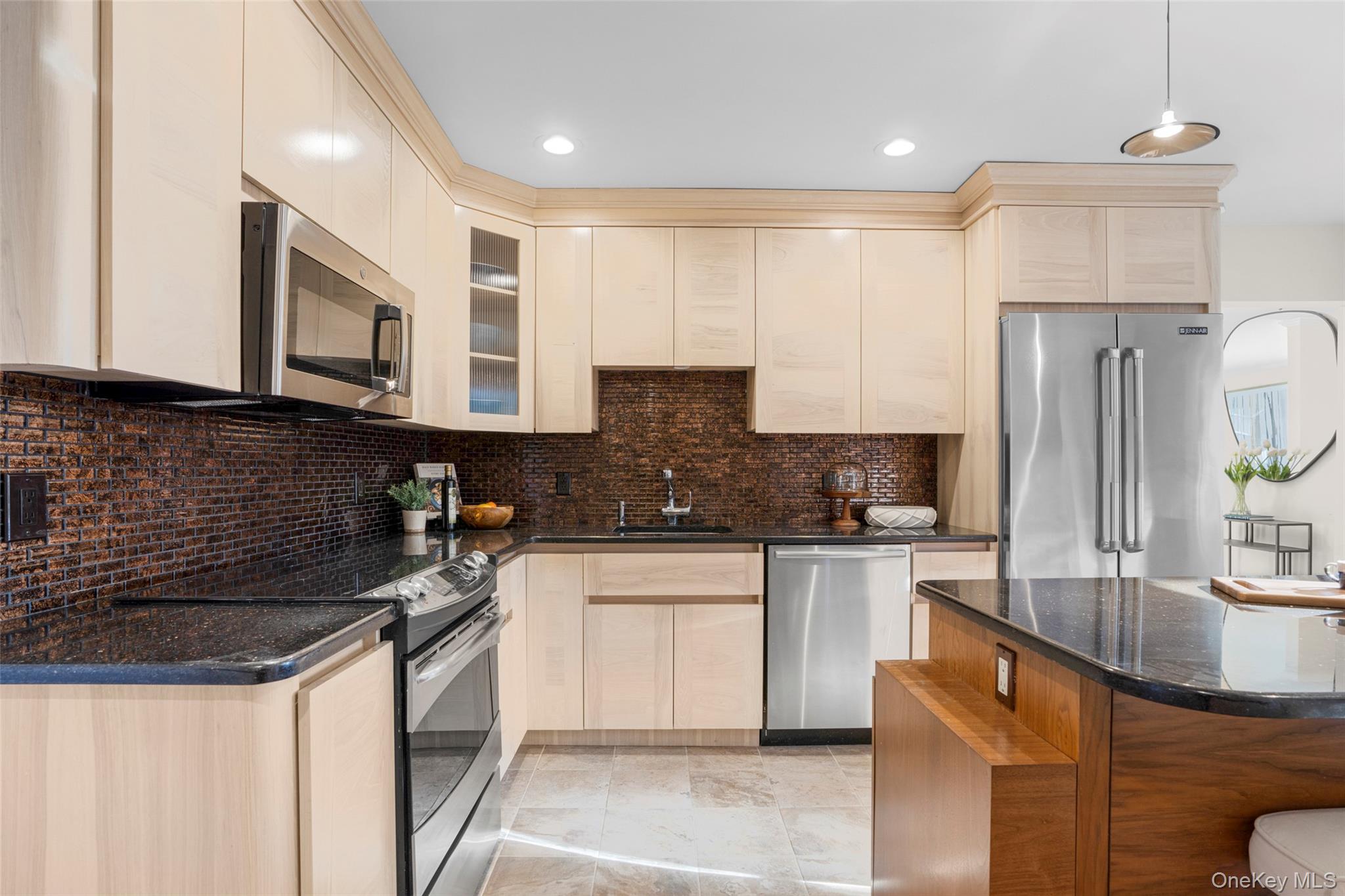 151 Hilburn Road Scarsdale, NY 10583 - Photo 10 of 40 a kitchen with stainless steel appliances granite countertop a sink a stove a refrigerator a microwave and cabinets