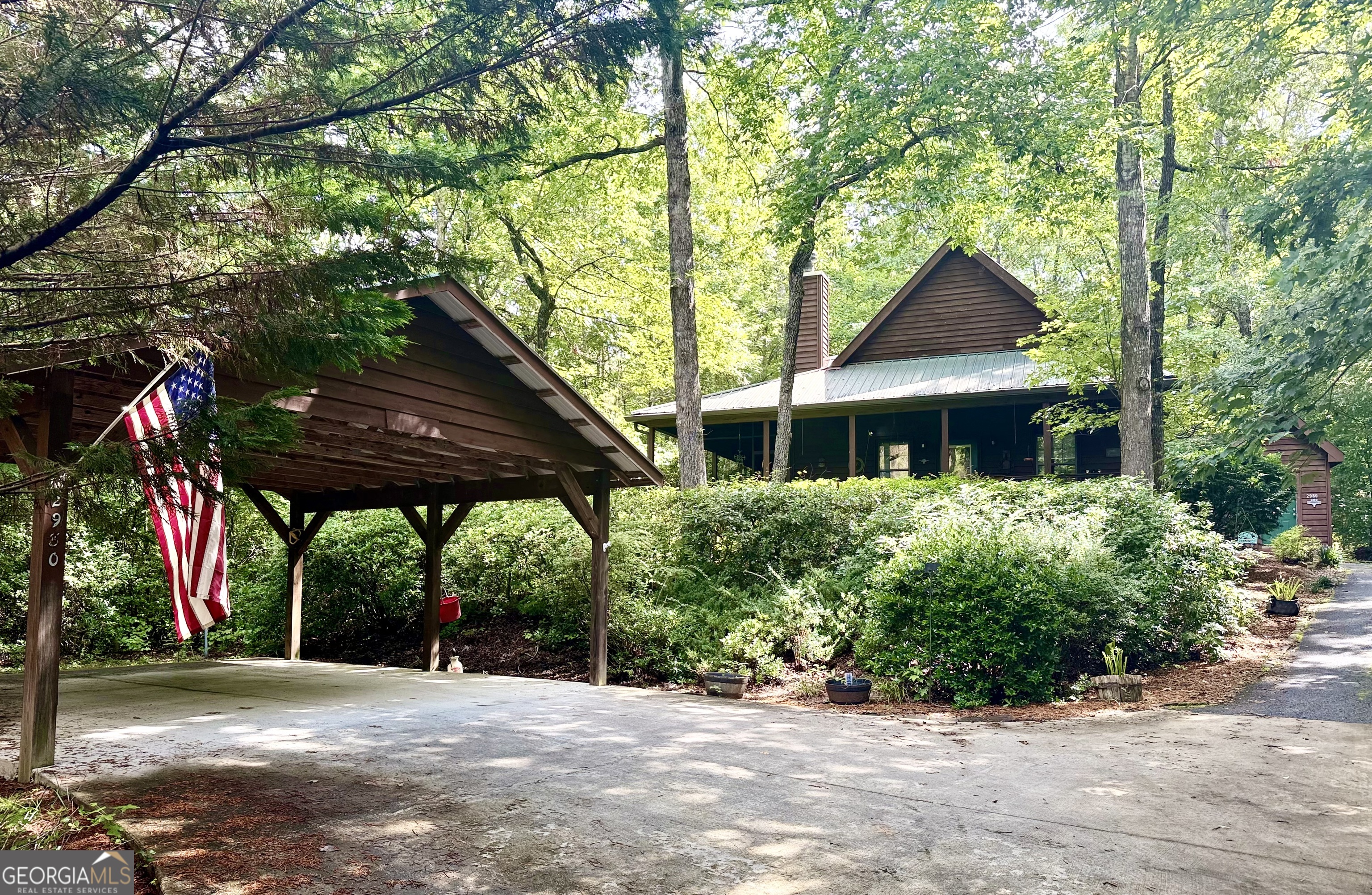 a front view of a house with a yard and potted plants