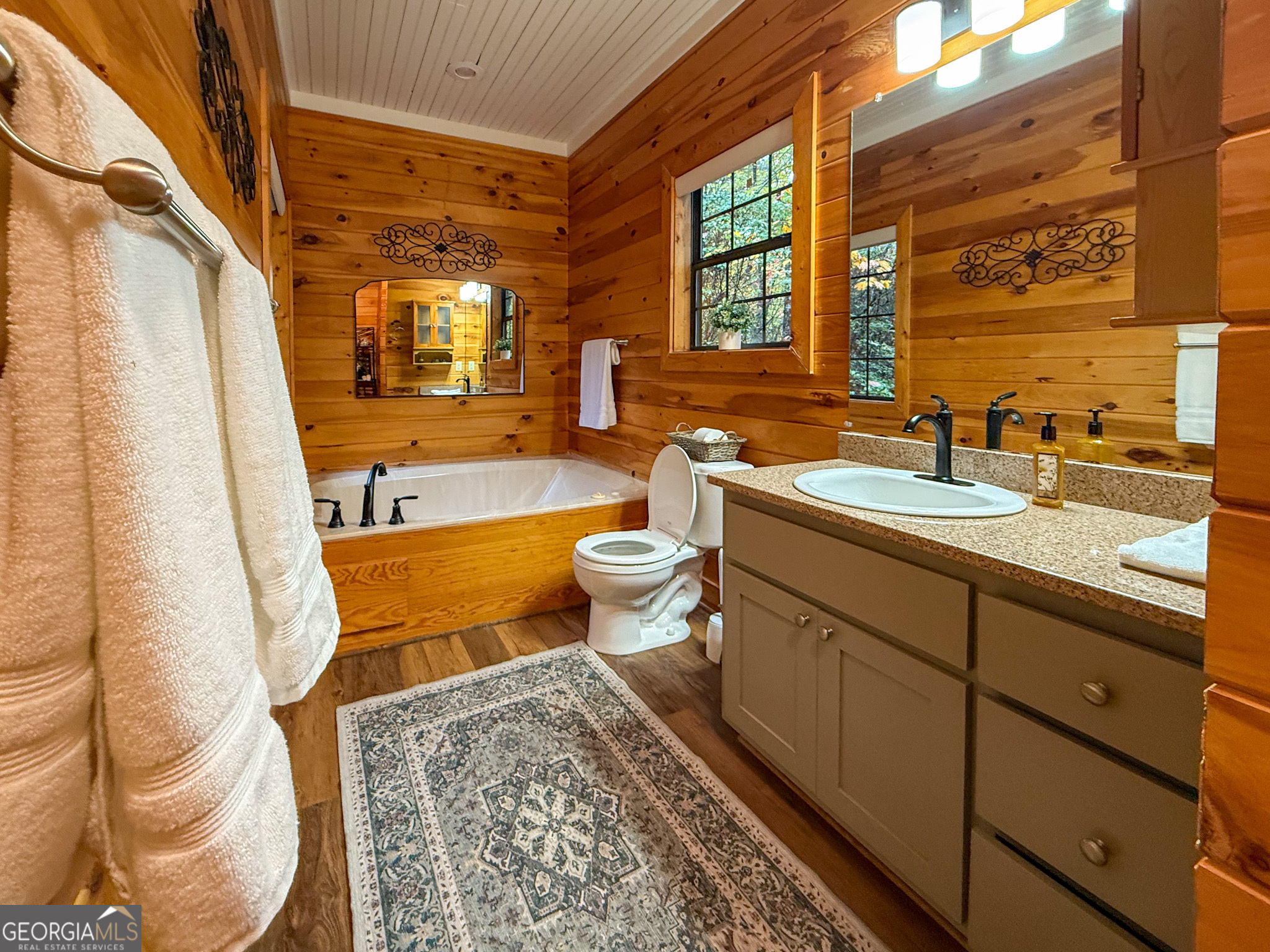 2980 Sky Lake Road Sautee Nacoochee, GA 30571 - Photo 11 of 22 a bathroom with a double vanity sink toilet and shower