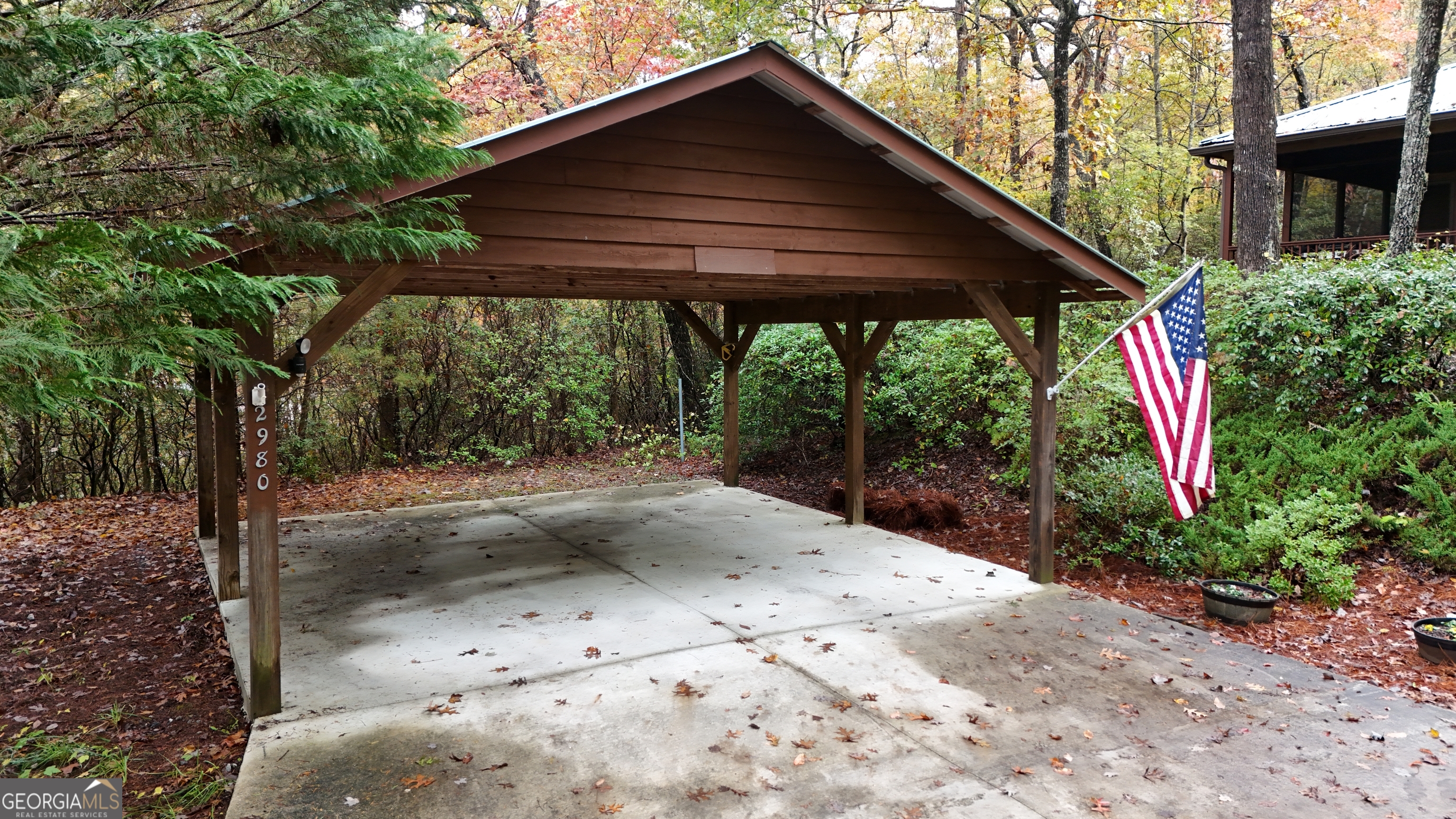 2980 Sky Lake Road Sautee Nacoochee, GA 30571 - Photo 20 of 22 a backyard of a house with large trees and wooden fence