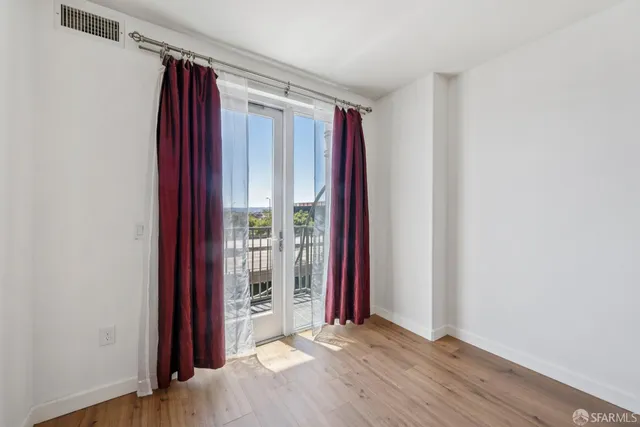 a view of a room with wooden floor and windows