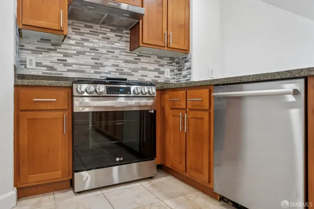 a stove top oven sitting inside of a kitchen