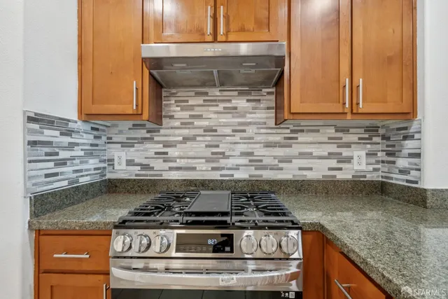 a stove top oven sitting inside of a kitchen