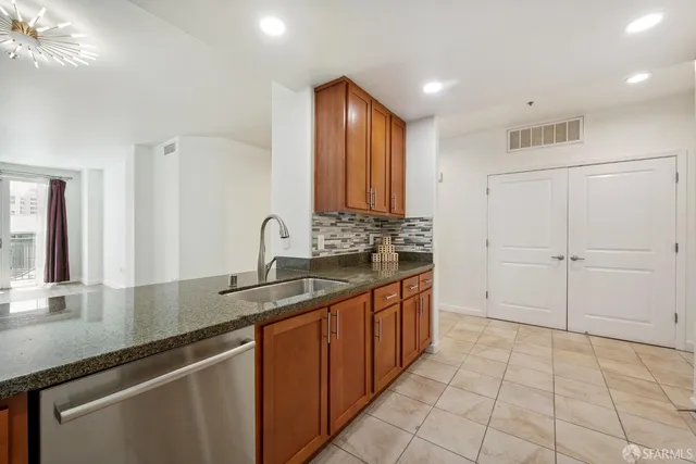 a kitchen with stainless steel appliances granite countertop a sink and a granite counter tops