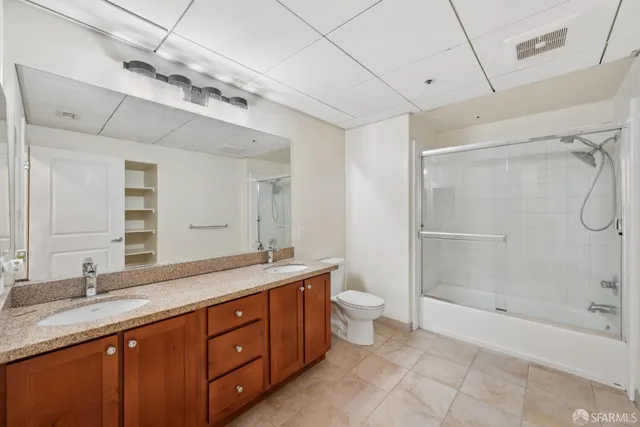 a spacious bathroom with a granite countertop sink mirror and shower
