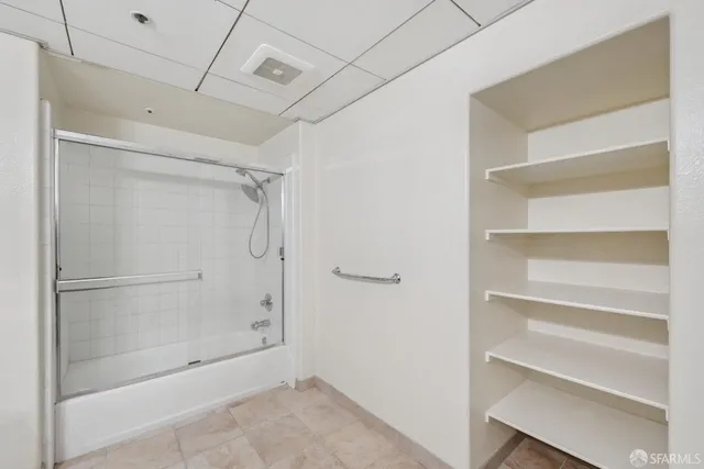 a bathroom with a glass shower door