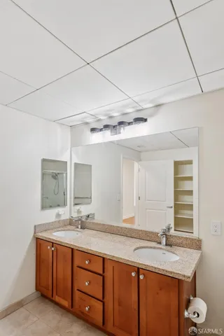 a bathroom with a granite countertop sink and a mirror