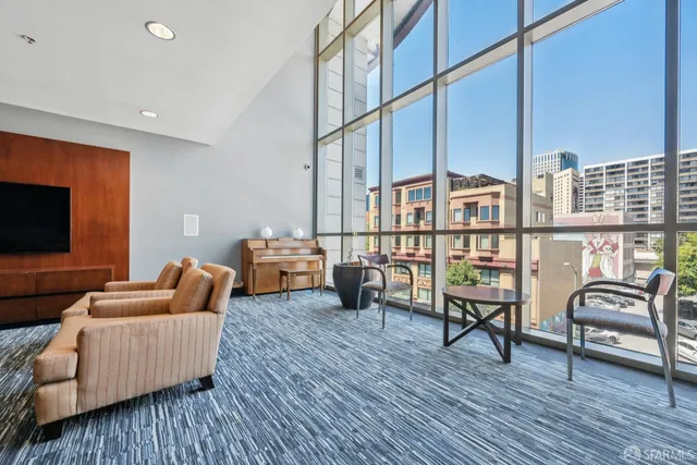 a view of a livingroom with furniture wooden floor and a ceiling fan
