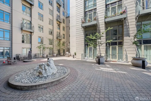 a view of a hallway with a door and chandelier