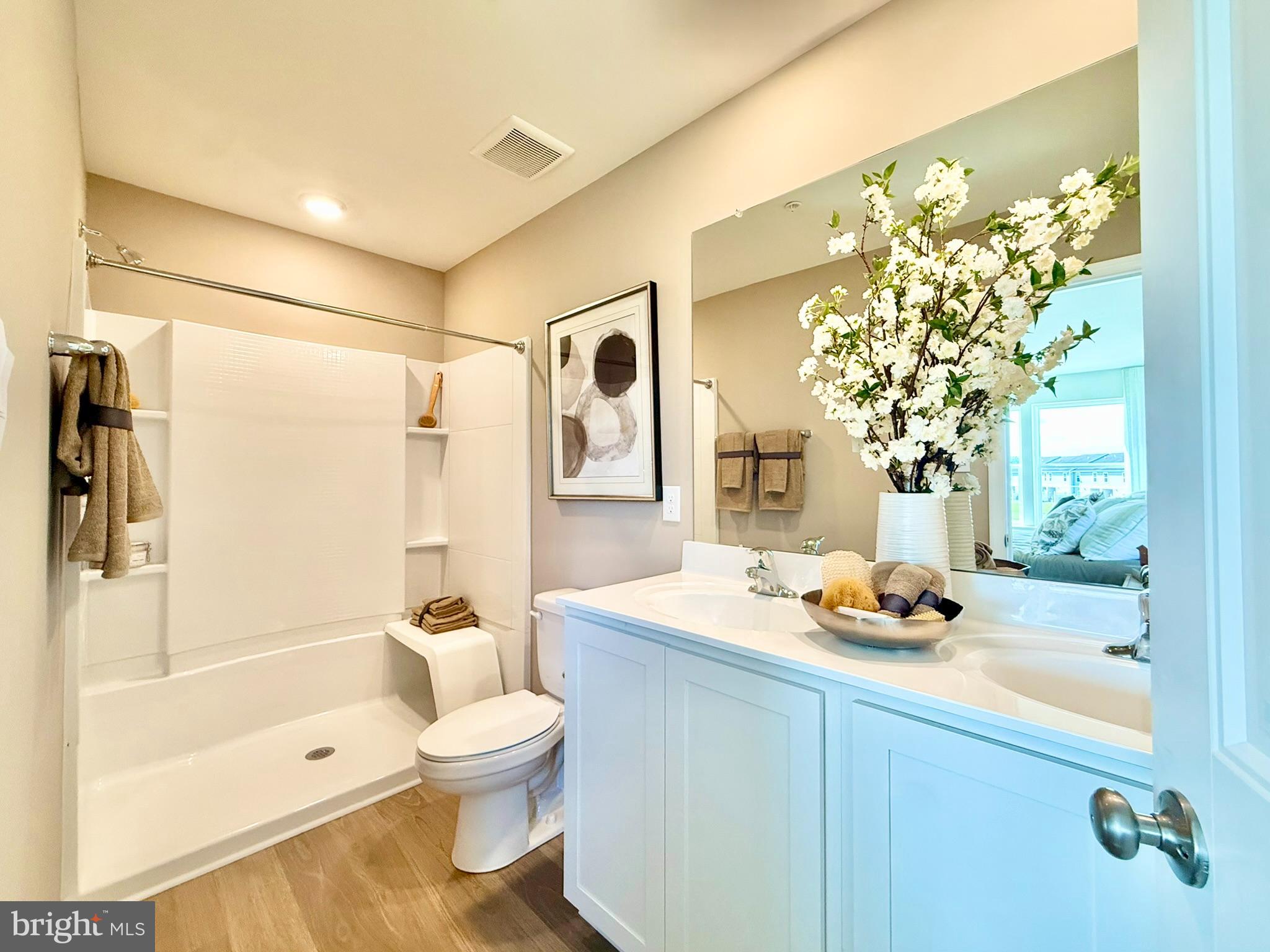 21456 Farmington Road Frankford, DE 19945 - Photo 19 of 30 a bathroom with a sink a toilet and shower
