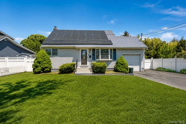 a front view of a house with a garden