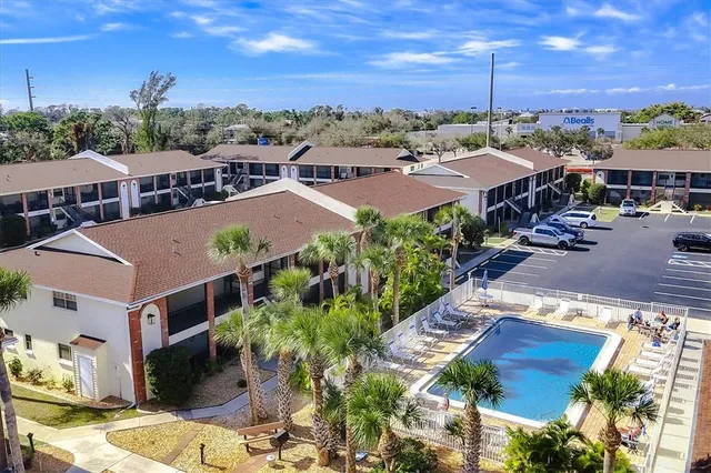an aerial view of residential building with yard