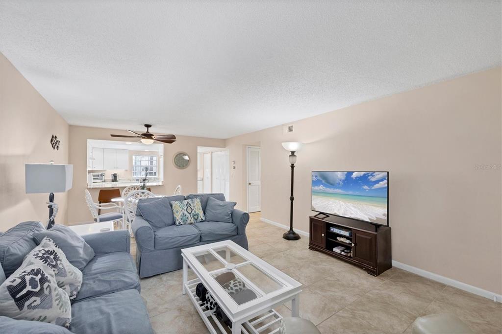 1531 Placida Road, Unit 4102 Englewood, FL 34223 - Photo 11 of 55 a living room with furniture a flat screen tv and a window
