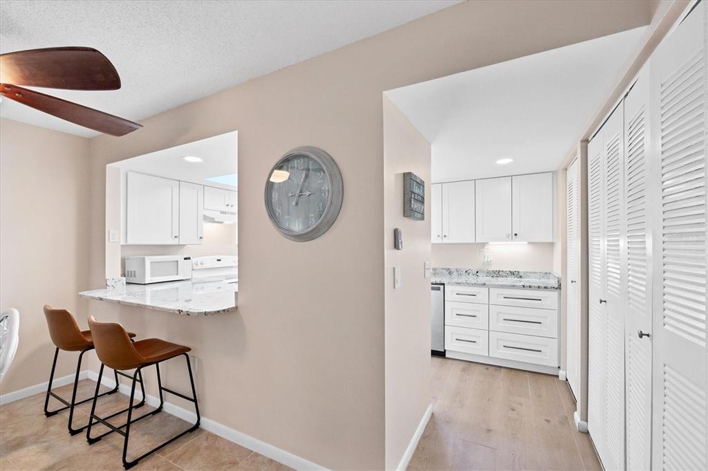 1531 Placida Road, Unit 4102 Englewood, FL 34223 - Photo 15 of 55 a room with a cabinets and a clock on the wall