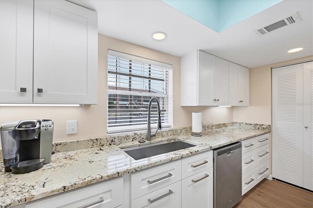 1531 Placida Road, Unit 4102 Englewood, FL 34223 - Photo 20 of 55 a kitchen with granite countertop cabinets sink and stainless steel appliances