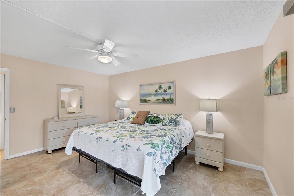 1531 Placida Road, Unit 4102 Englewood, FL 34223 - Photo 25 of 55 a bedroom with a bed and a chandelier