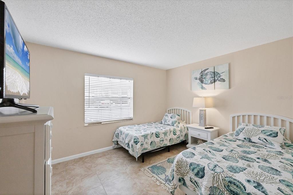 1531 Placida Road, Unit 4102 Englewood, FL 34223 - Photo 29 of 55 a bedroom with two beds and a flat screen tv