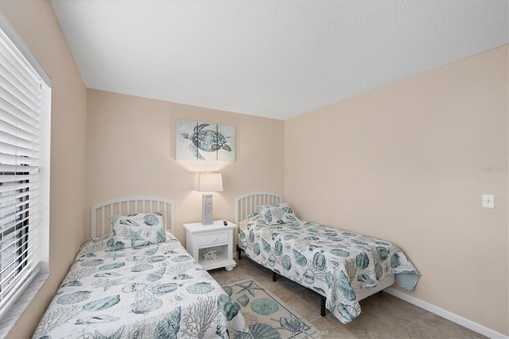1531 Placida Road, Unit 4102 Englewood, FL 34223 - Photo 30 of 55 a bedroom with double bed and a window