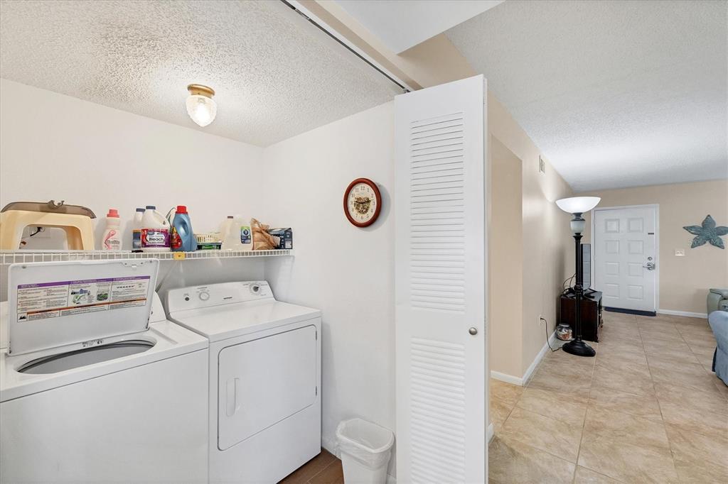1531 Placida Road, Unit 4102 Englewood, FL 34223 - Photo 32 of 55 a utility room with dryer and washer