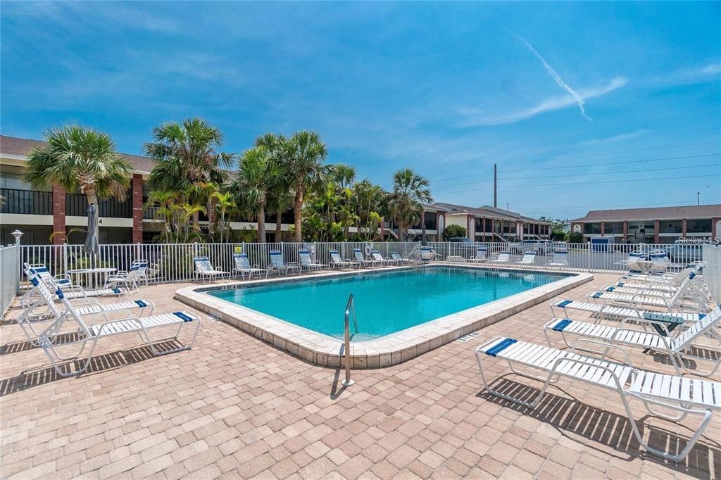 1531 Placida Road, Unit 4102 Englewood, FL 34223 - Photo 35 of 55 a view of a swimming pool with a lounge chairs