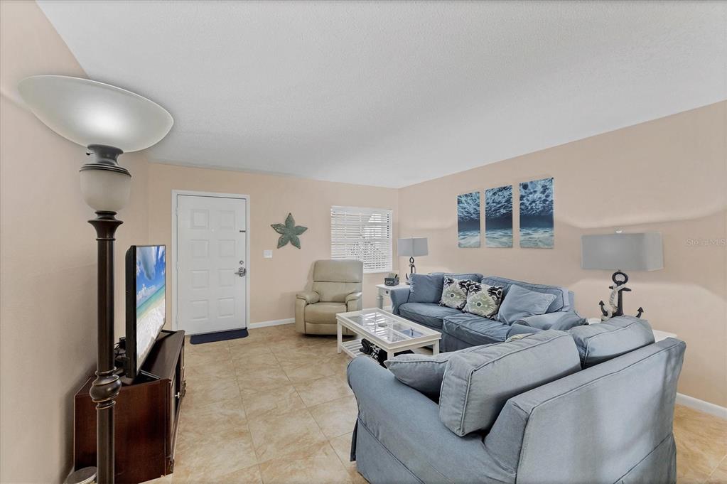 1531 Placida Road, Unit 4102 Englewood, FL 34223 - Photo 9 of 55 a living room with furniture and a flat screen tv