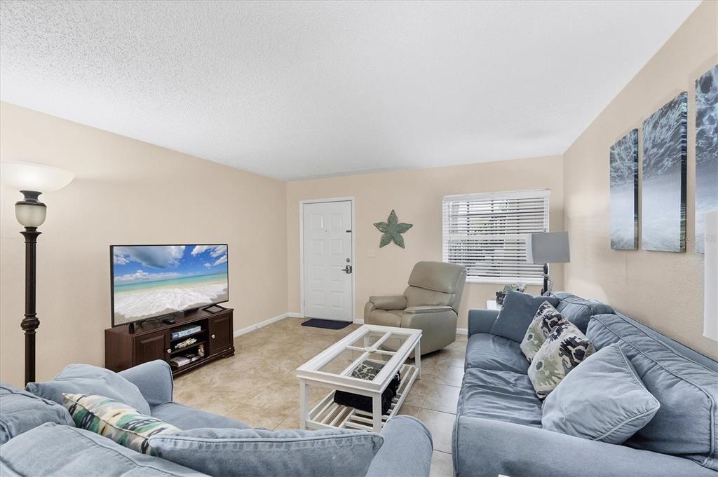 1531 Placida Road, Unit 4102 Englewood, FL 34223 - Photo 10 of 55 a living room with furniture and a flat screen tv