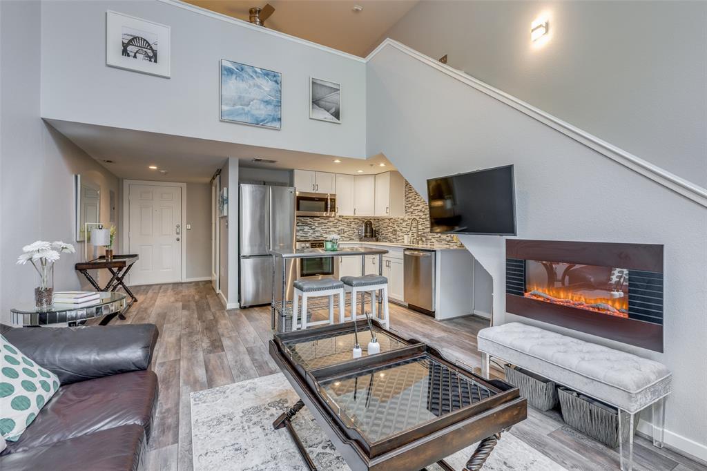 5111 Manett Street, Unit 208 Dallas, TX 75206 - Photo 1 of 13 a living room with furniture and a flat screen tv