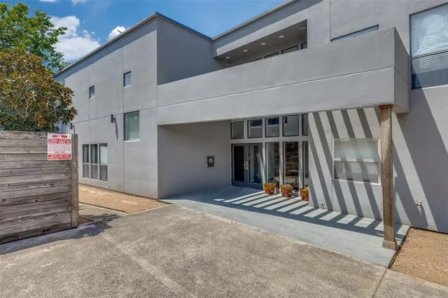 a view of a house with stairs and wooden fence