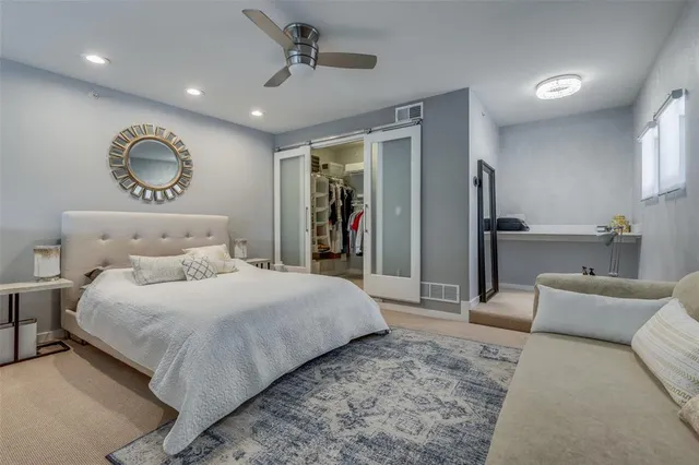 a bedroom with a large bed and a chandelier