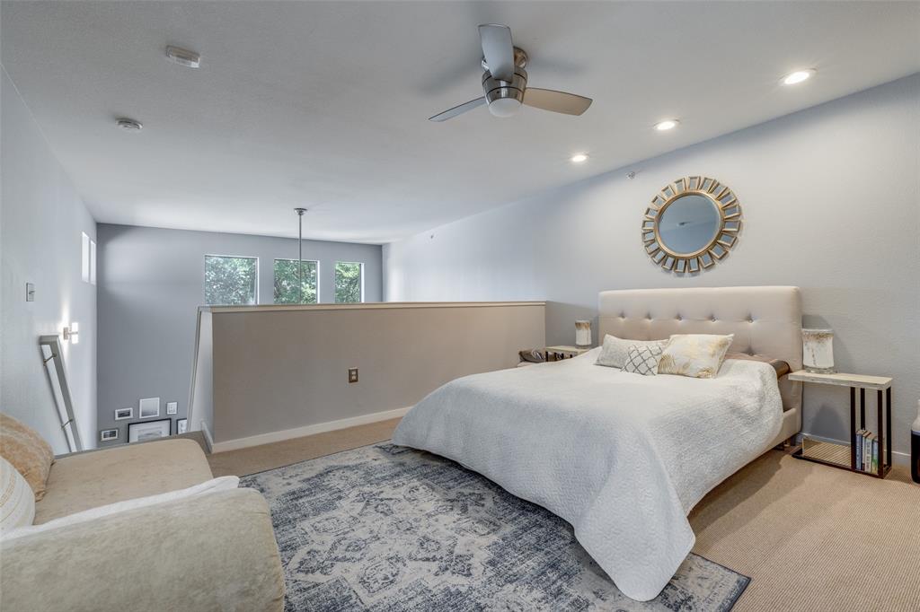 5111 Manett Street, Unit 208 Dallas, TX 75206 - Photo 8 of 13 a bedroom with a bed and a chandelier