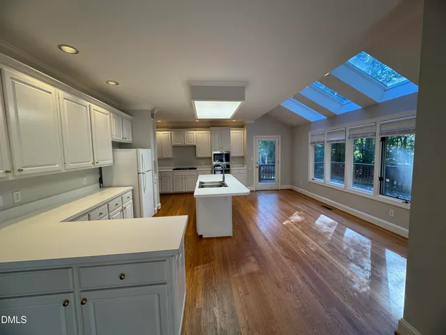 a living room with furniture and kitchen view