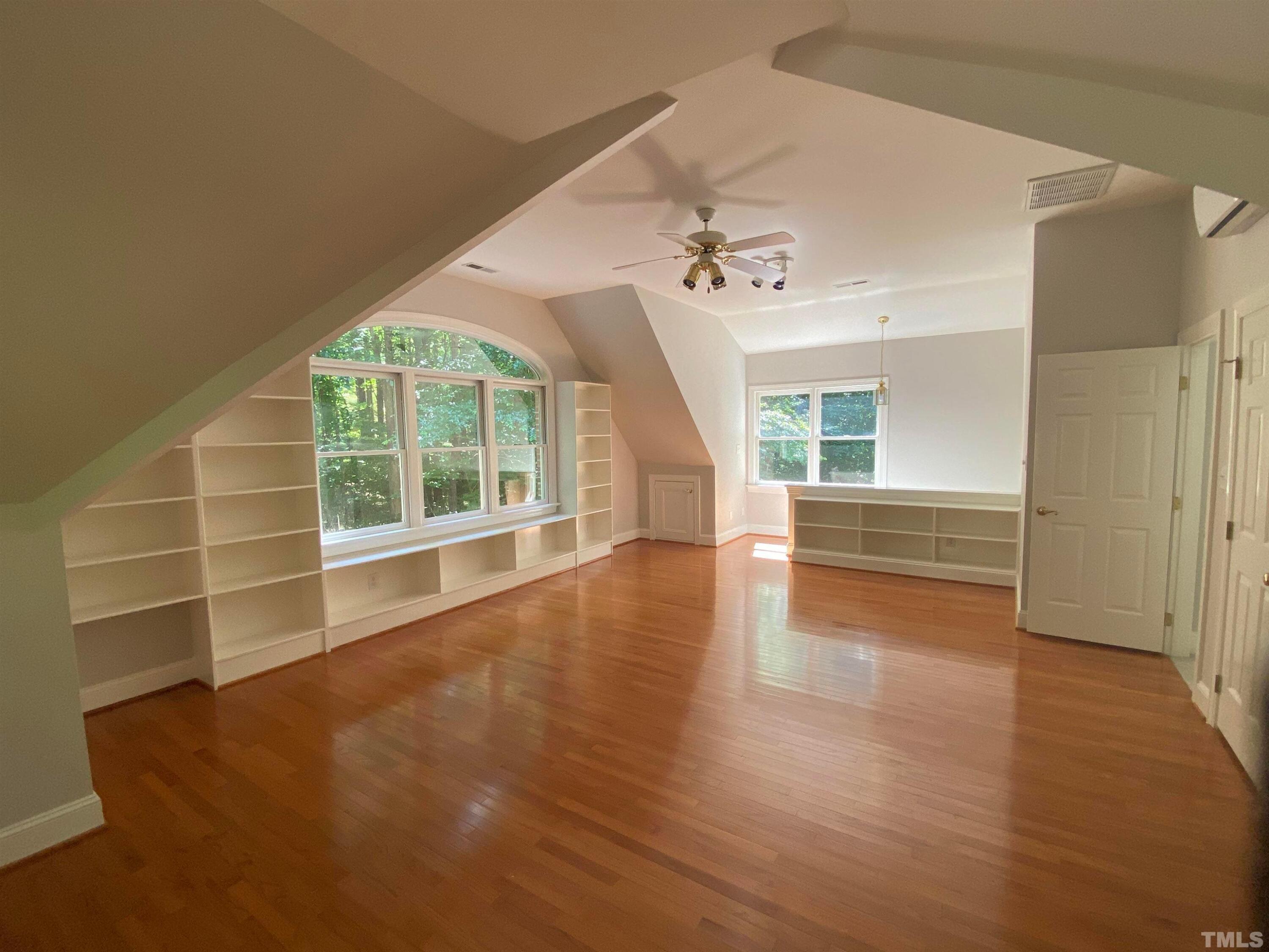 10621 Cahill Road Raleigh, NC 27614 - Photo 14 of 32 a view of an empty room with a window and wooden floor