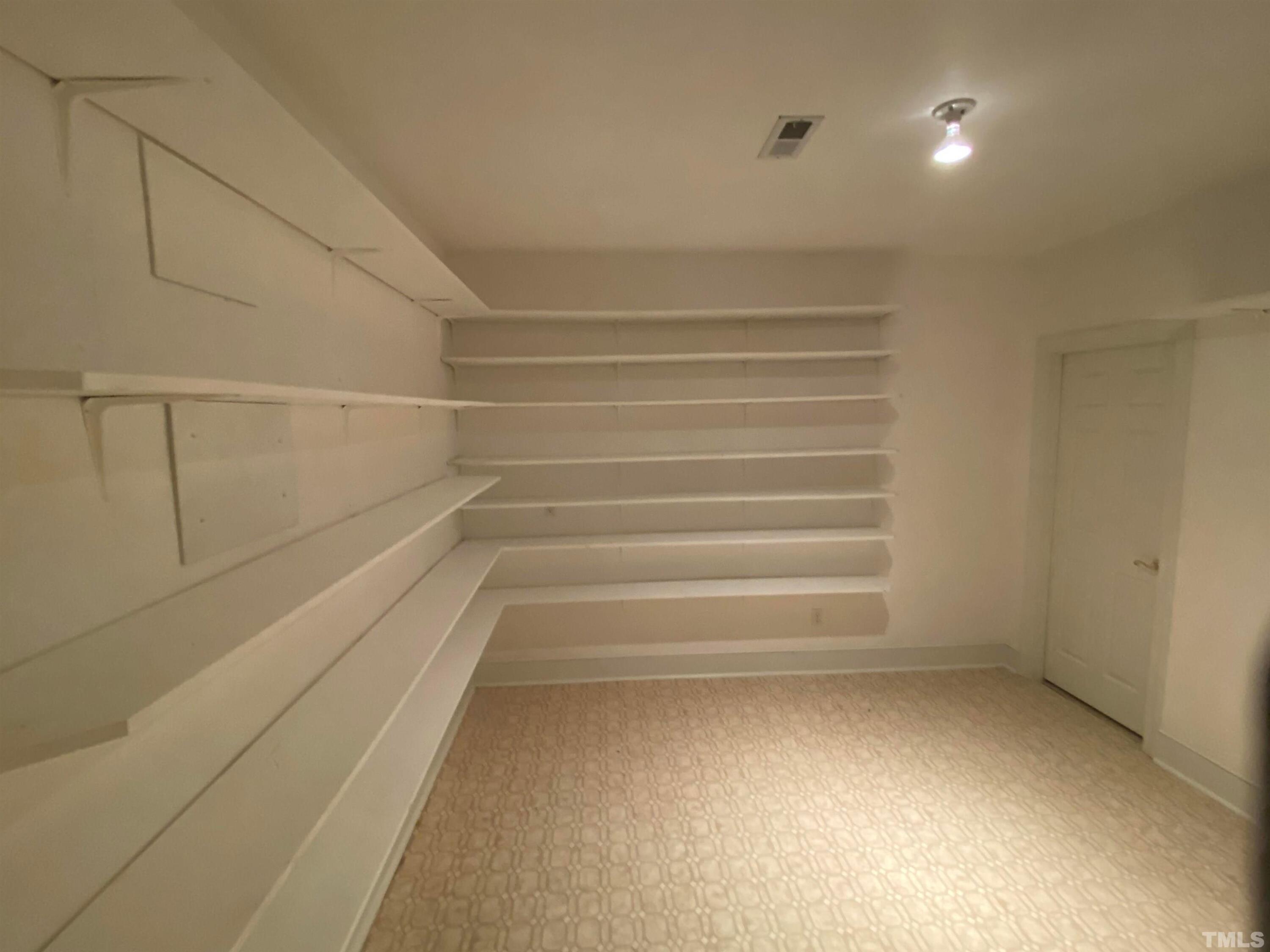 10621 Cahill Road Raleigh, NC 27614 - Photo 17 of 32 a view of walk in closet with empty racks