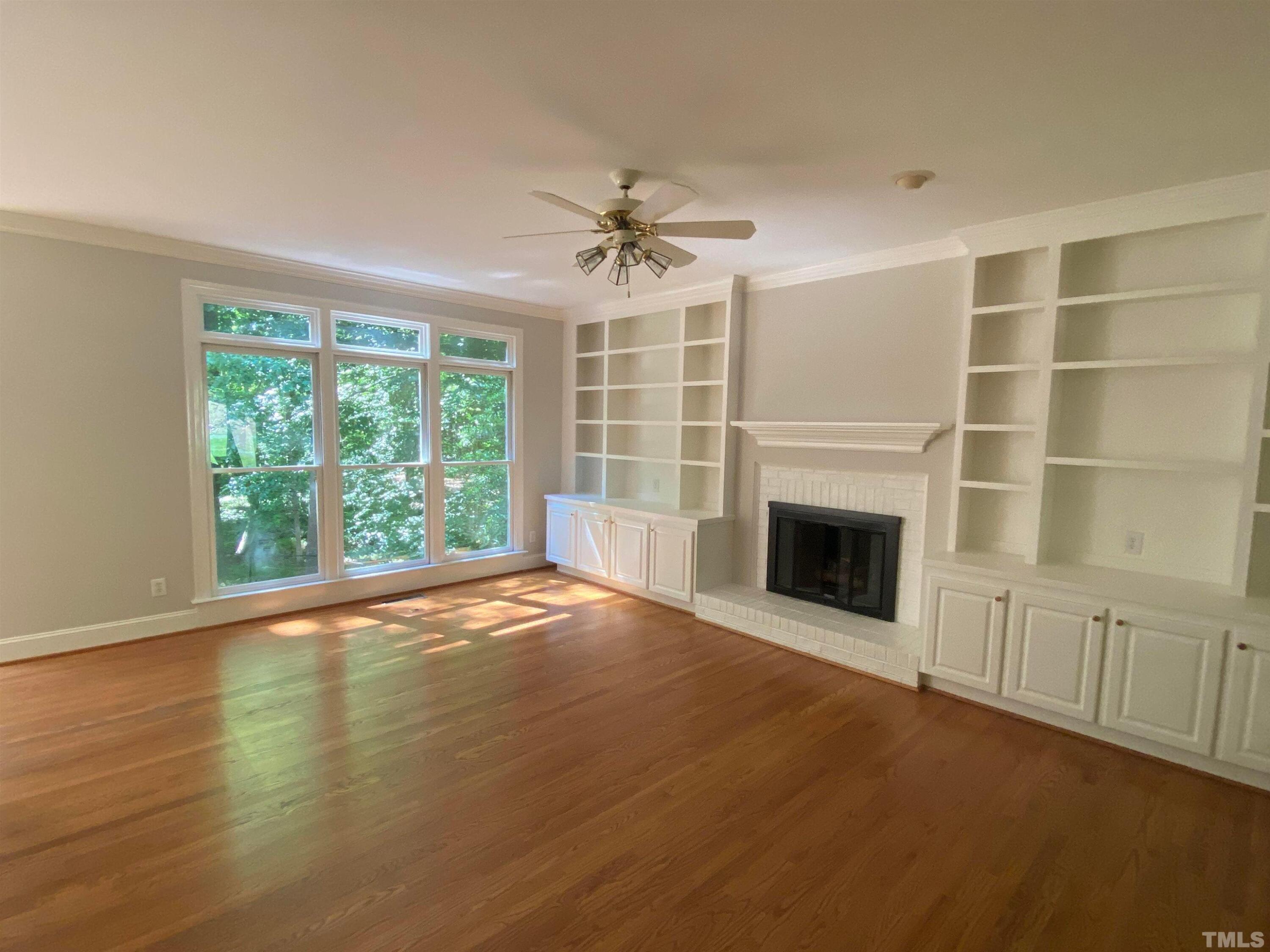 10621 Cahill Road Raleigh, NC 27614 - Photo 2 of 32 a view of an empty room with a fireplace and a window