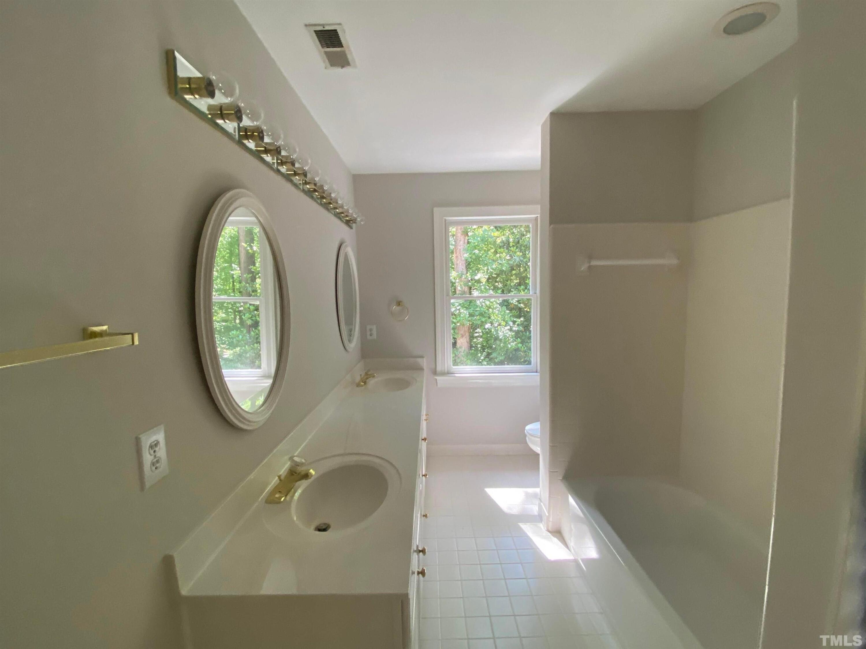 10621 Cahill Road Raleigh, NC 27614 - Photo 22 of 32 a bathroom with a sink and a mirror