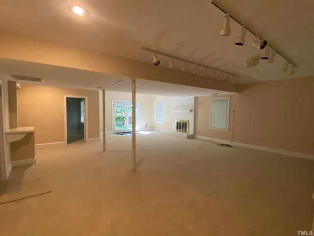 a view of a big room with closet and windows