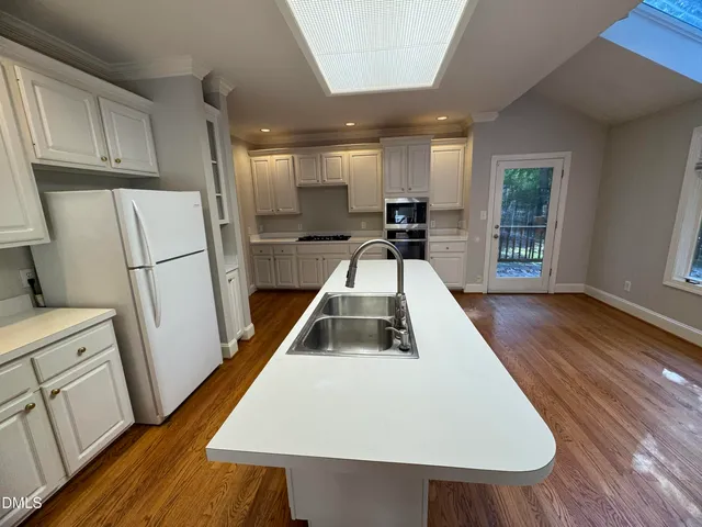 a white refrigerator freezer sitting inside of a kitchen