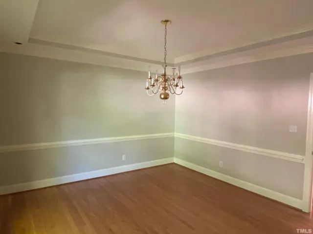 a view of a room with a window and wooden floor