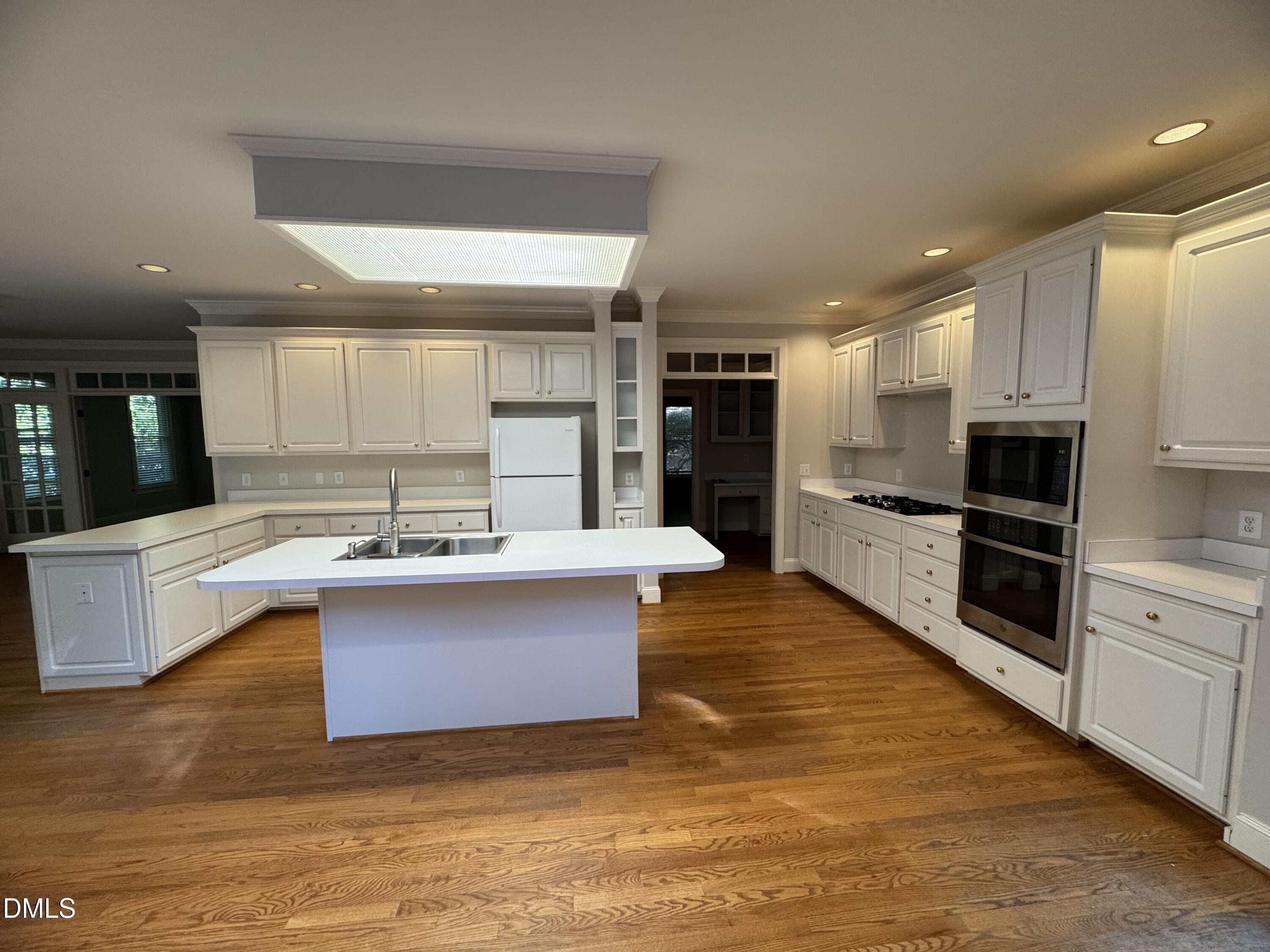 10621 Cahill Road Raleigh, NC 27614 - Photo 10 of 32 a large kitchen with stainless steel appliances kitchen island granite countertop a large counter top and a stove