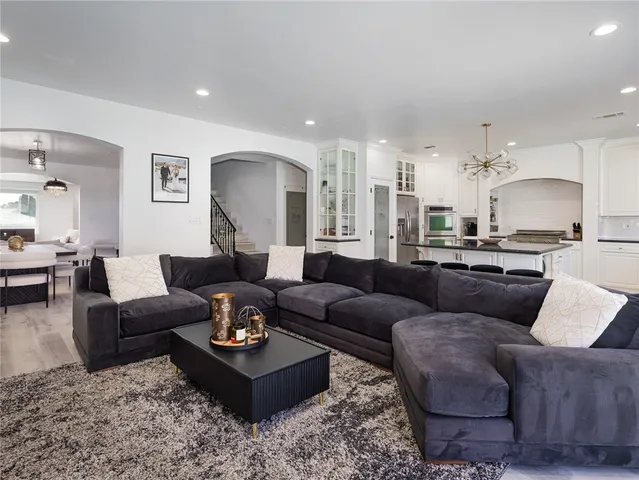 a living room with furniture and view of kitchen