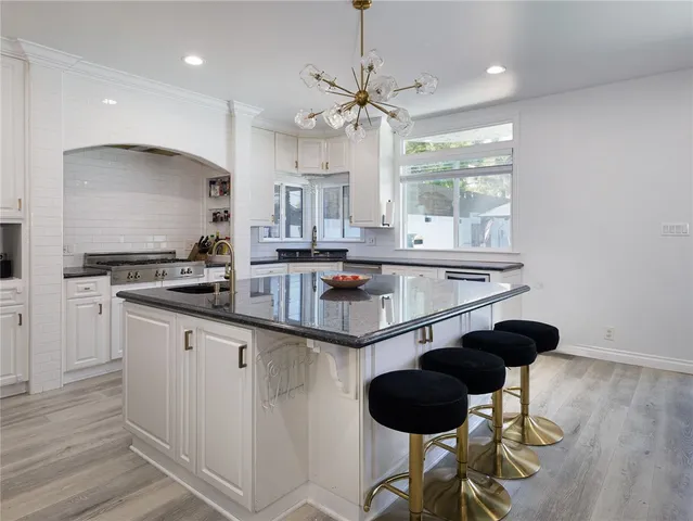 a kitchen with stainless steel appliances granite countertop a sink and cabinets