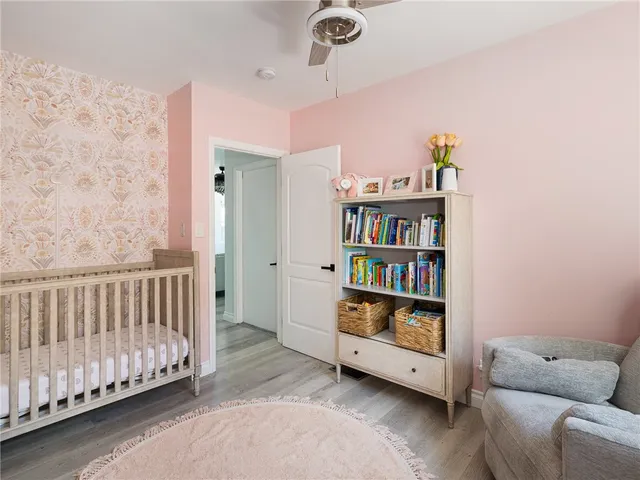 a living room with furniture and a book shelf