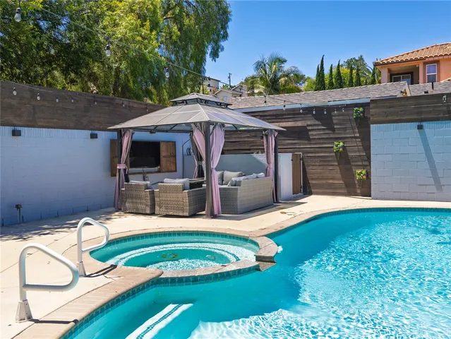 a view of a backyard with furniture and a tub