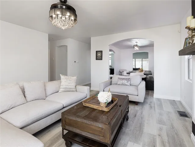 a living room with furniture or kitchen and a chandelier
