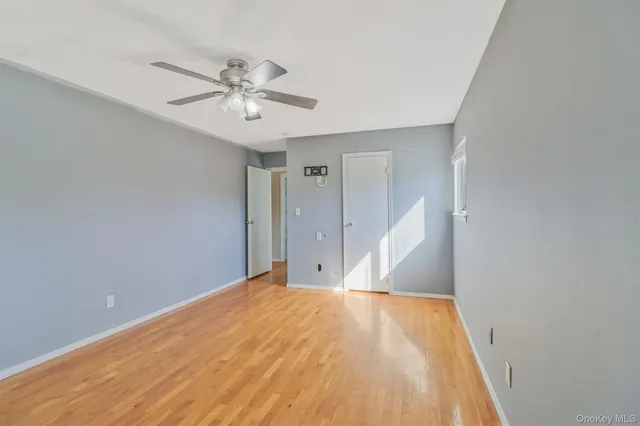 a view of a big room with wooden floor and closet in a room