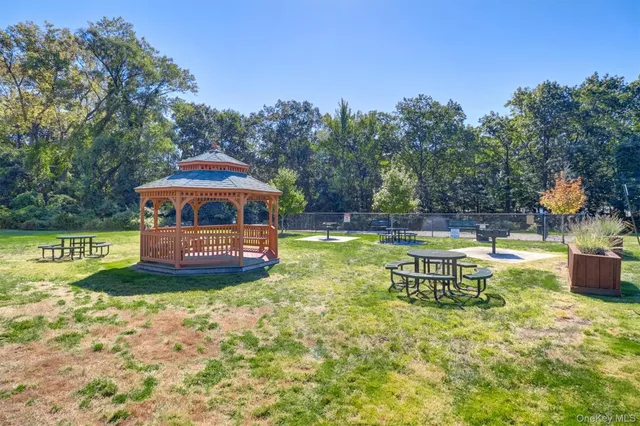 a view of a house with garden and sitting area