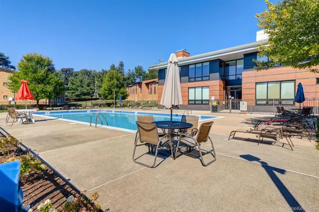 a front view of a house with garden and sitting area